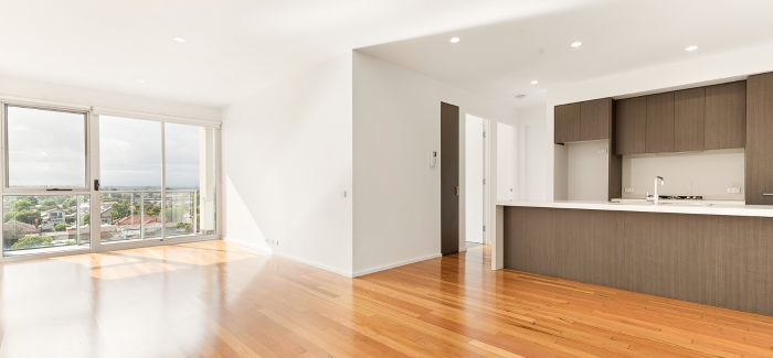 Wide-frame view of a bright, empty apartment.
