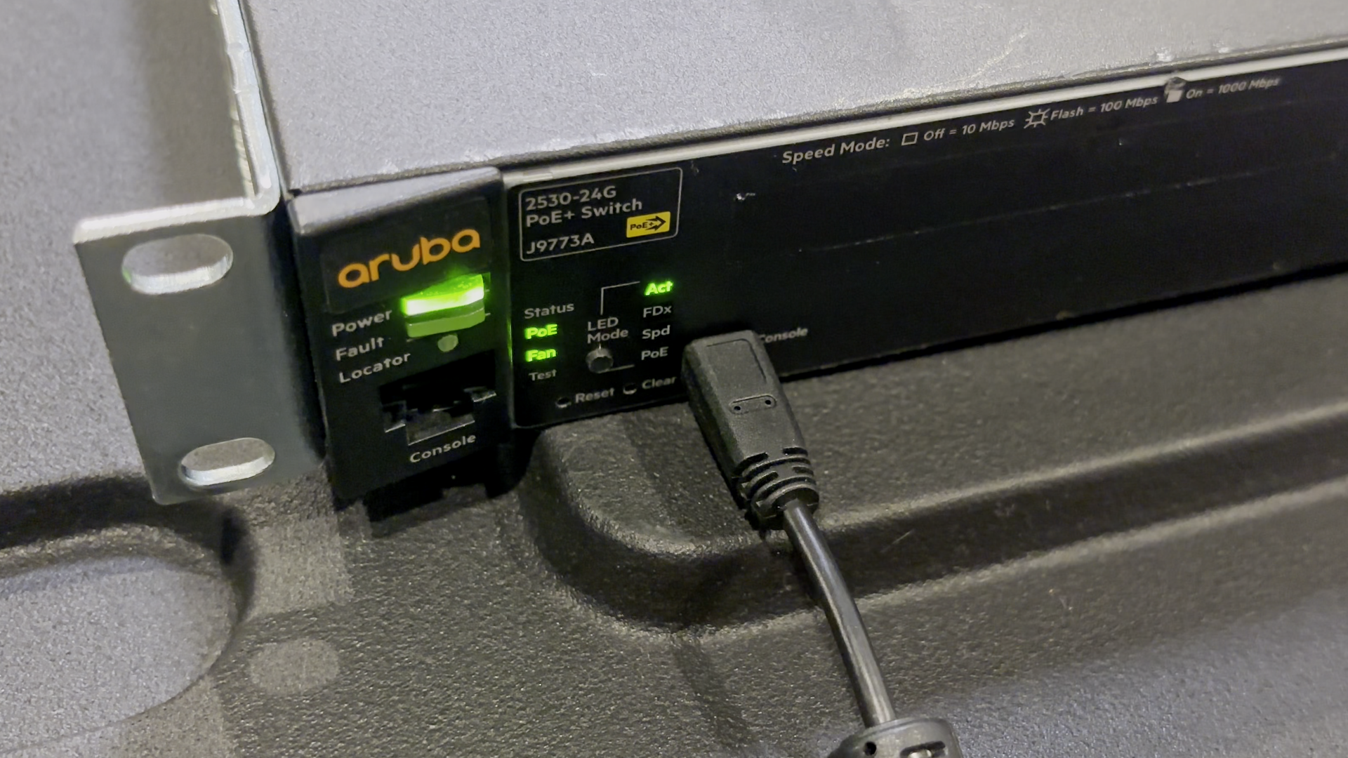 A photo of a serial device with a cable connected to its Console port.