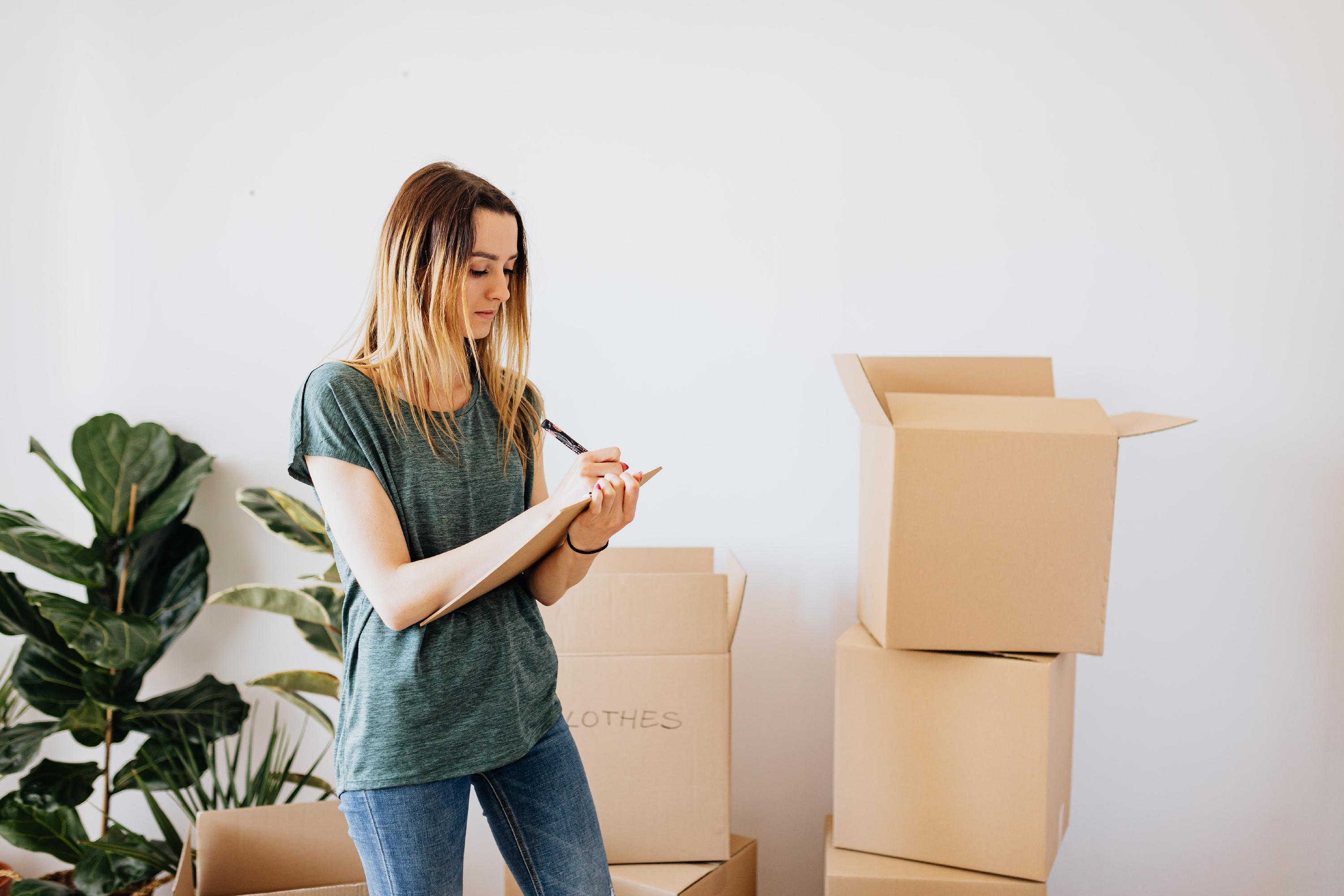 Woman making moving checklist 