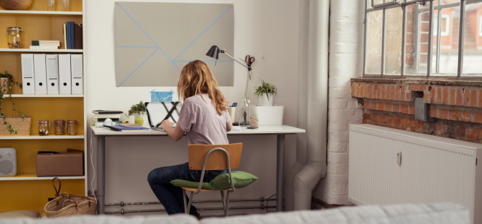 Student studying at a desk in an apartment.