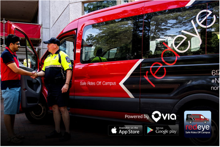 Red Eye Shuttle van and driver shaking hands with a student 