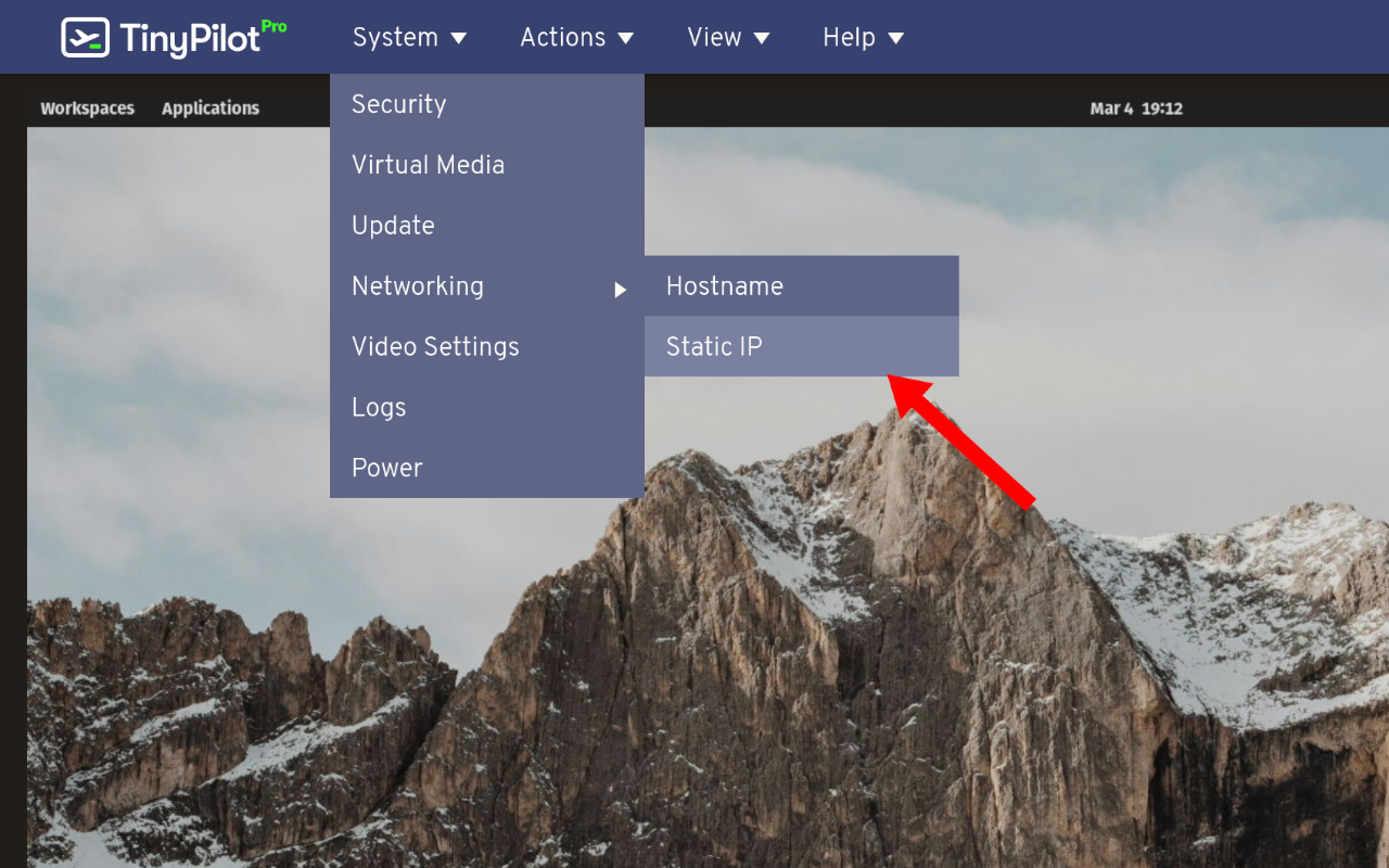 A screenshot of TinyPilot's web interface. The 'system' menu is open, along with the 'Networking' submenu. The 'Networking' submenu shows 'Static IP' highlighted. A red arrow points to the 'Static IP' menu item.