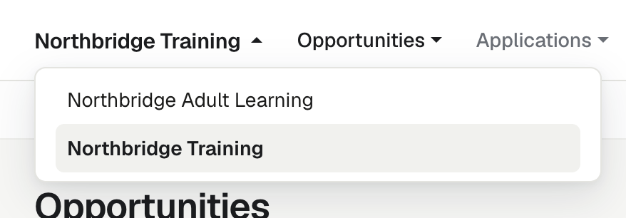 The organisation switcher open in the header, listing two organisations with the current one highlighted.